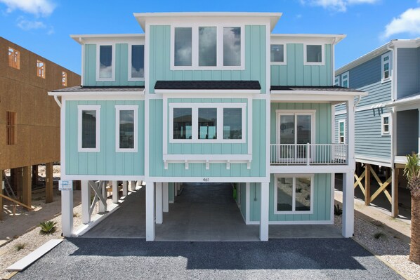 A two-story building with a balcony, a covered entryway, and a visible address number. - "Dune Our Thing II" New Construction 8 Bedroom, 8 Bathroom Oceanfront Home w/ Pool! (Holden Beach)