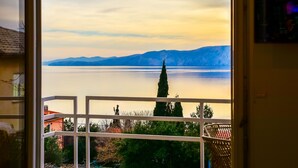A view from a balcony overlooking a lake with mountains in the distance. - Apartment Sanja by Interhome (Novi Vinodolski)