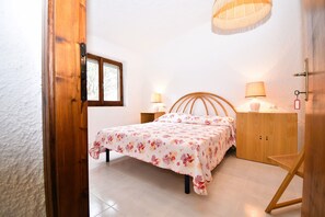 Relax in this serene bedroom with a comfortable bed, bedside tables, and a wardrobe.