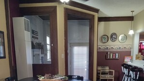A dining area with a round table, white chairs, and a ceiling fan. - Our Guest house is a cozy get away, in a small town.  (Grey Eagle)