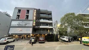 A multi-story building with a sign for 'Golf Co-Working' and a 'Shutter Down' notice. - Saltstayz Express - Golf Course Road & DLF Phase-1 (Gurugram)