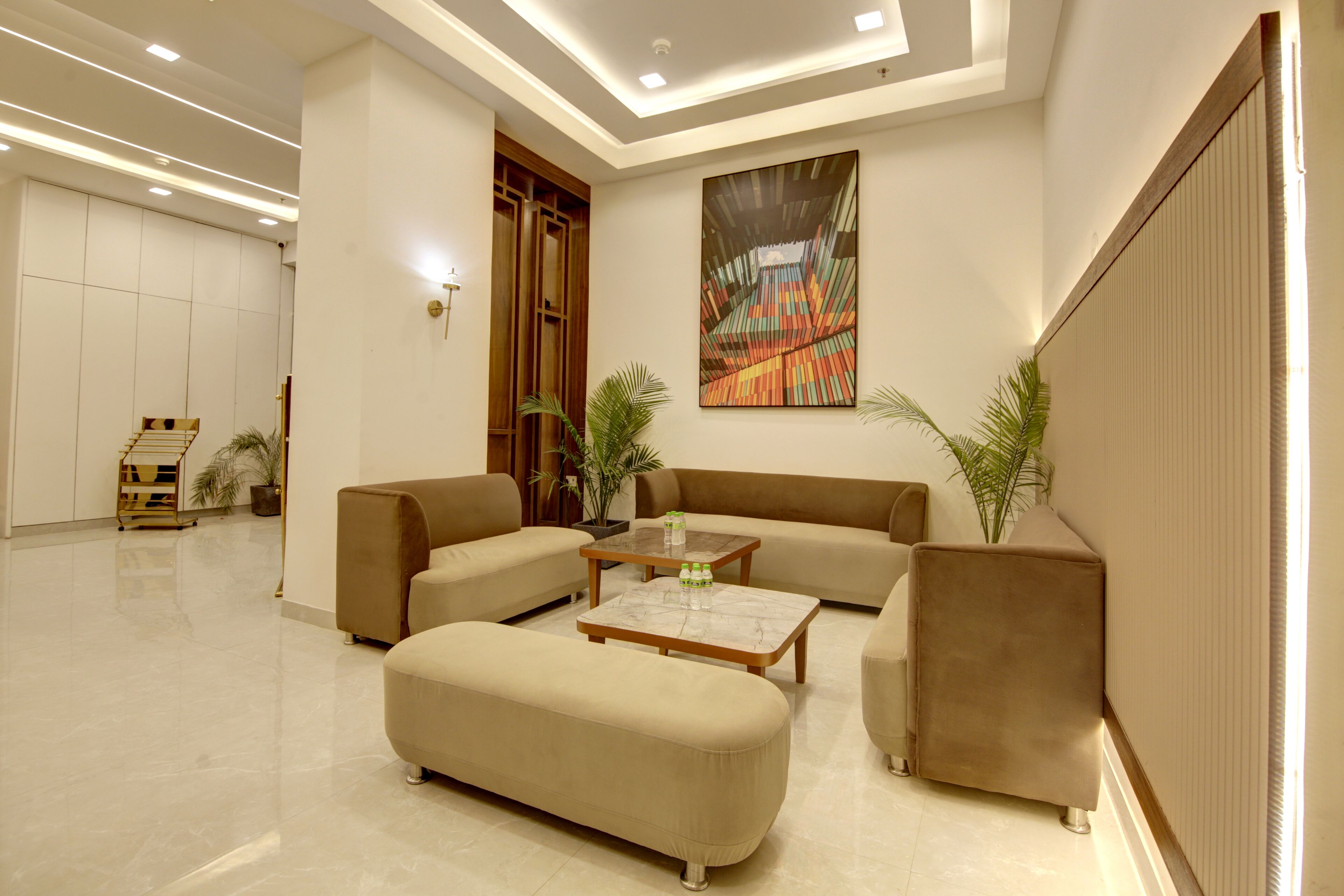 A modern living room with a sofa set, a coffee table, and two potted plants.
