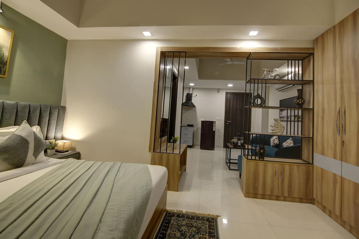 A modern bedroom with a bed, bedside table, and a wardrobe.