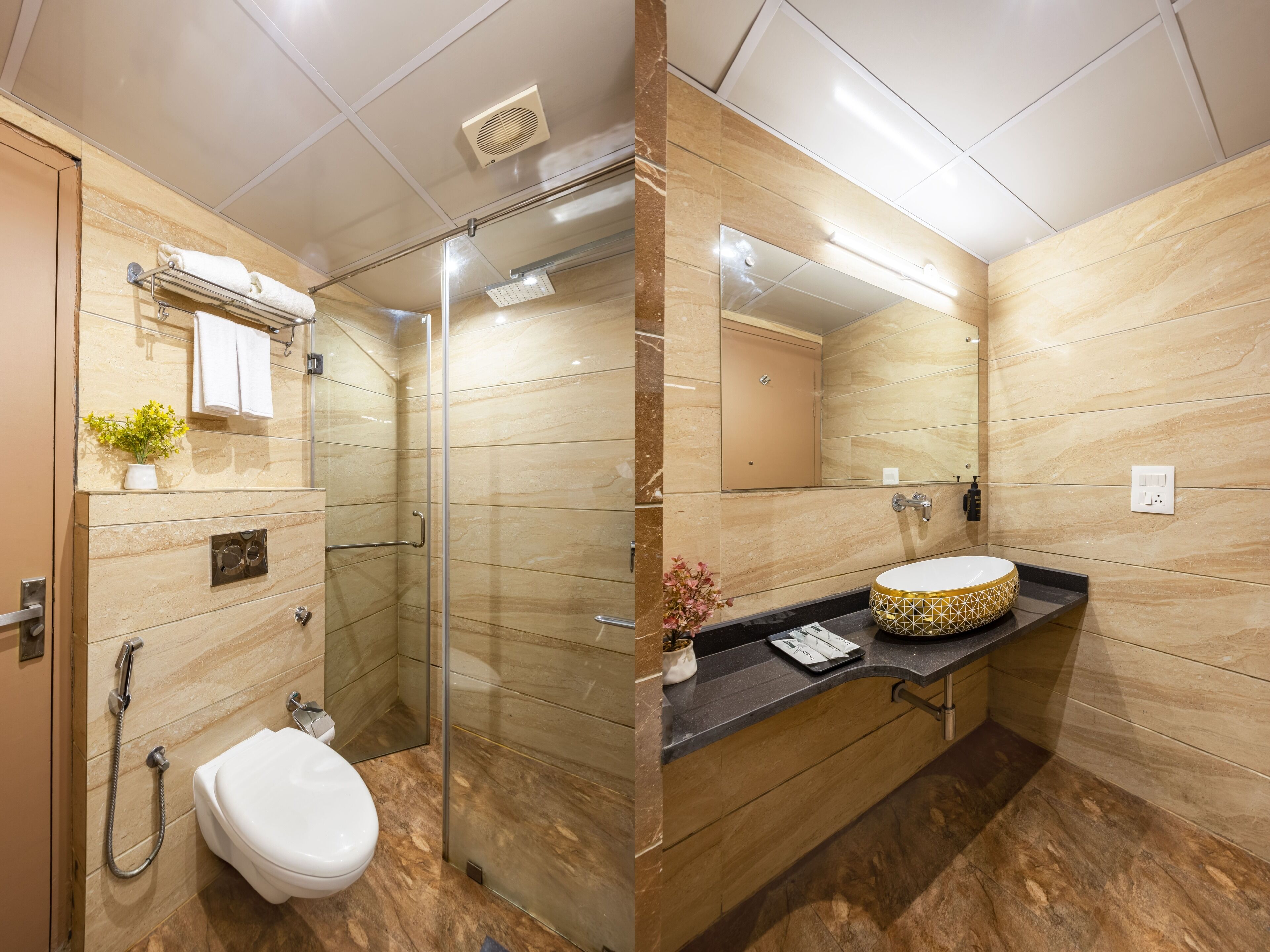 A modern bathroom with a glass-enclosed shower, a white toilet, and a vanity with a round sink and decorative bowl.