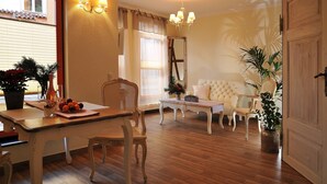 A dining area with a table, chairs, and a chandelier. - Apartment 'Wohnung 'am Kütertor' - Störtebeker' with Private Terrace and Wi-Fi (Stralsund)