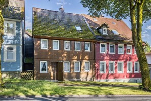 A row of traditional European-style houses with distinct architectural features, including sloped roofs and wooden facades.