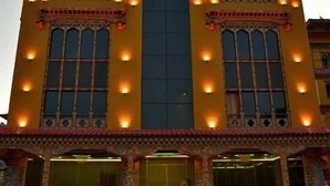 A multi-story building with ornate architectural details and multiple windows. - Pema Yangsel Hotel (Paro)