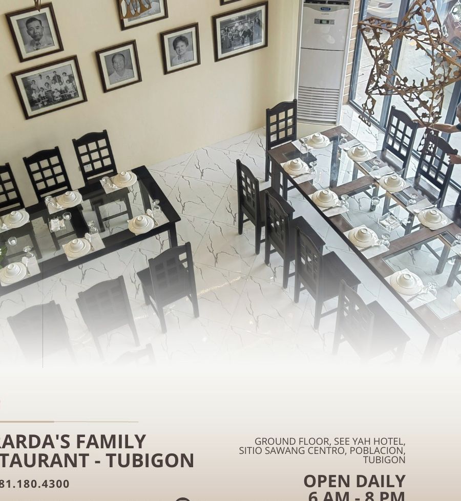 Gerarda's Family Restaurant - Tubigon with a dining area featuring tables set for service, framed pictures on the wall, and a staircase leading to an upper level.