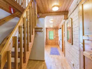 A wooden staircase leading to a room with a window and a door. - Vacation home Paju 7 by Interhome (Loviisa)