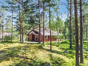 A cabin surrounded by tall trees in a forested area. - Vacation home Paju 7 by Interhome (Loviisa)