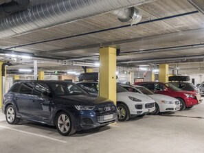 A parking garage with multiple cars parked in designated spaces. - Villa jääpolte by Interhome (Kittilä)
