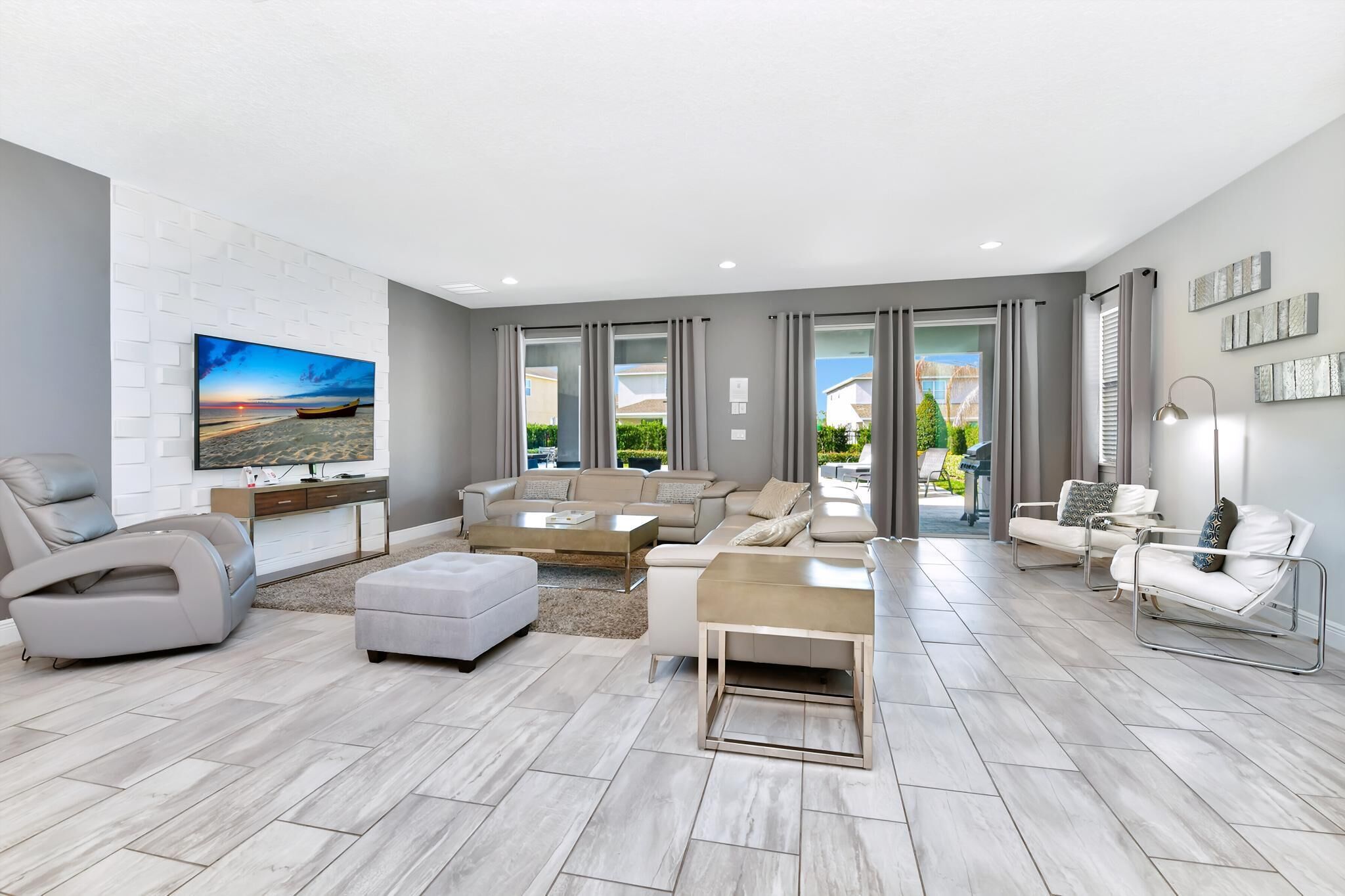 A modern living room with a flat-screen TV, a sofa set, a coffee table, and a TV stand.