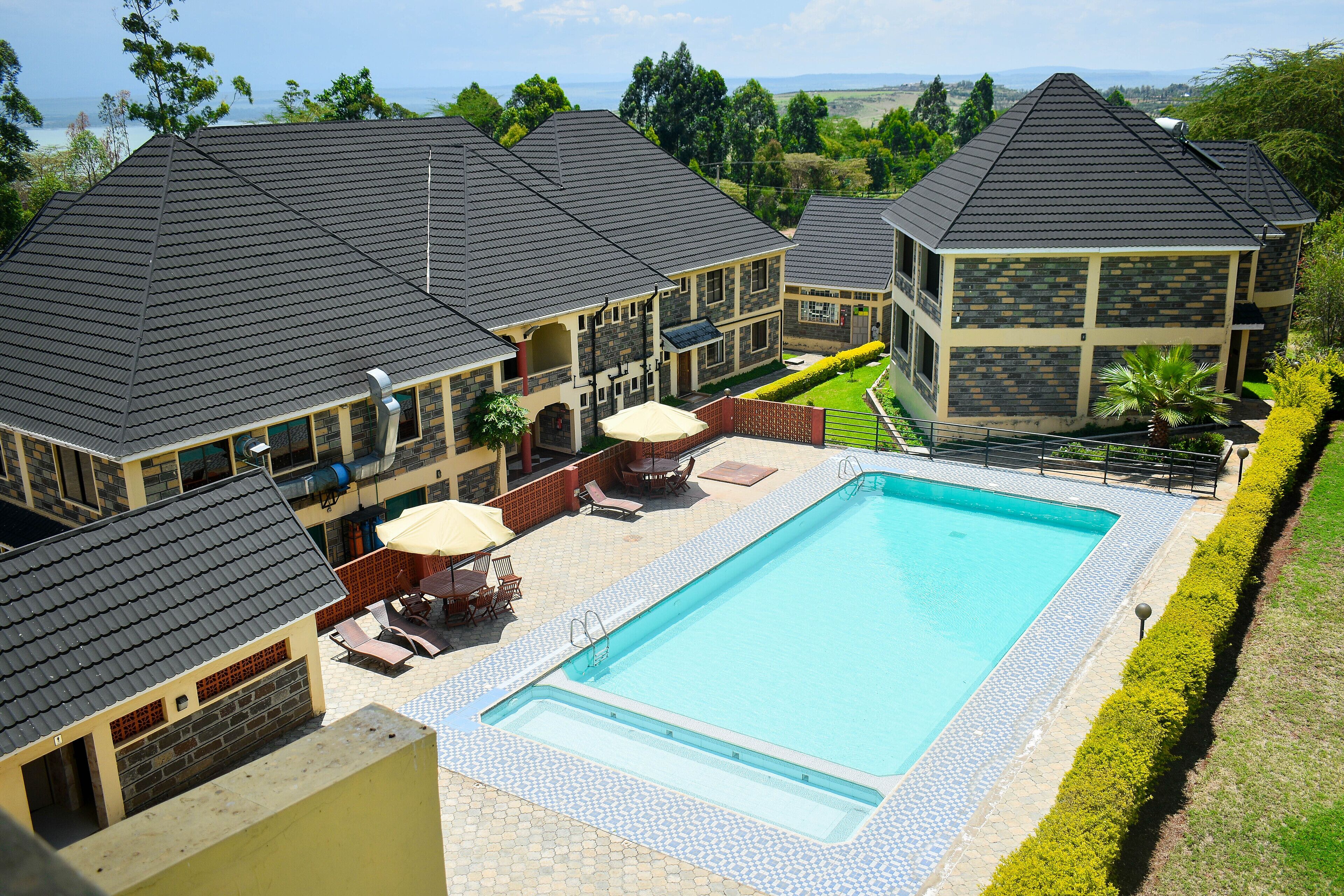 Una piscina al aire libre, sillones reclinables de piscina