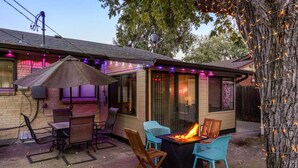 A patio with a fire pit, outdoor seating, and string lights. - Insta-Worthy 5BR Home I Pet Friendly  I Firepit (Denver)