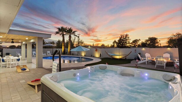 A backyard with a hot tub, a pool, and outdoor seating. - Private Pickleball, B-Ball, Putt, Pool, Spa, Grill (Scottsdale)