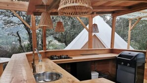 Eine Holz-Küche mit Spüle, Herd und Grill.