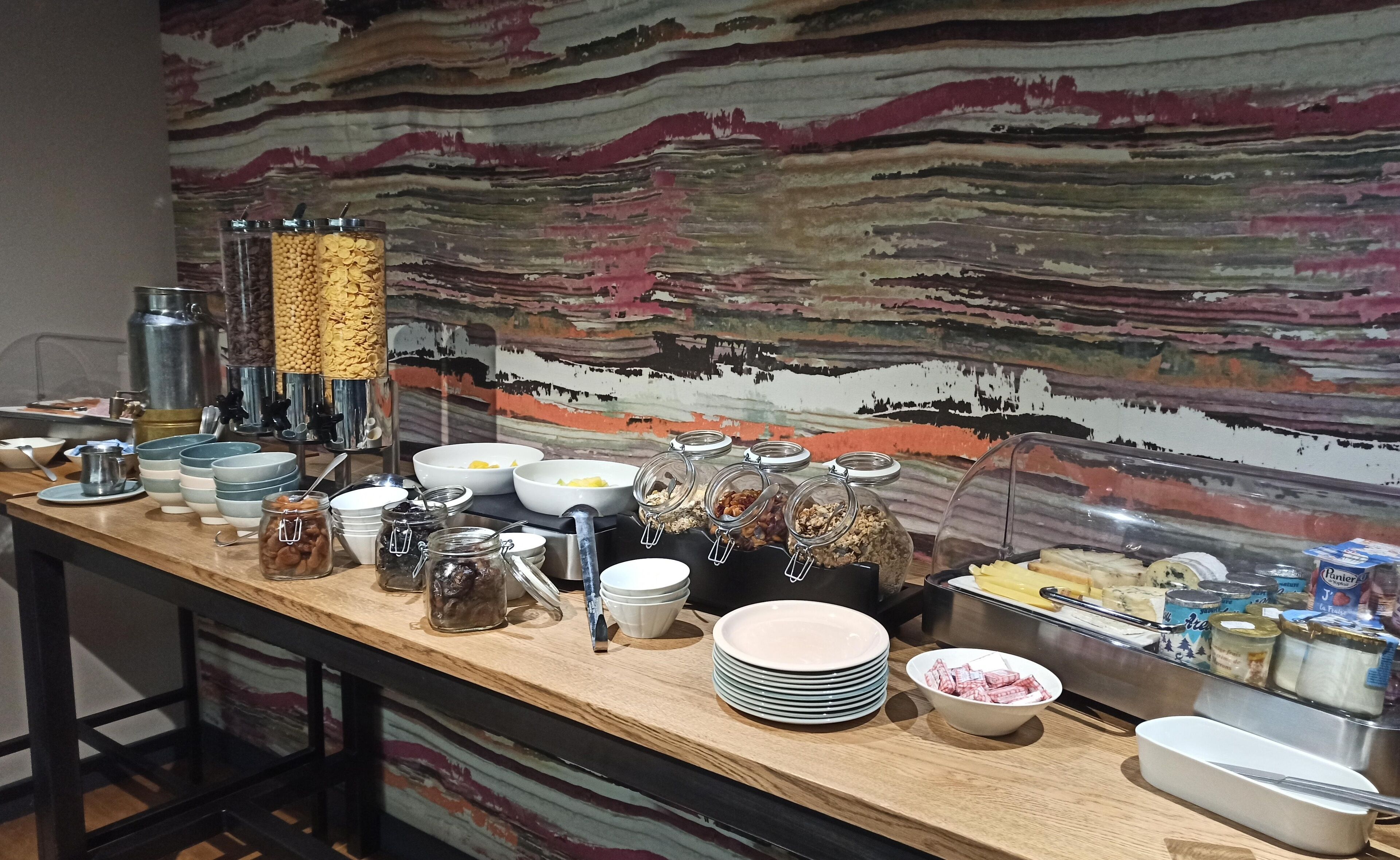 A buffet setup with various food items and utensils.
