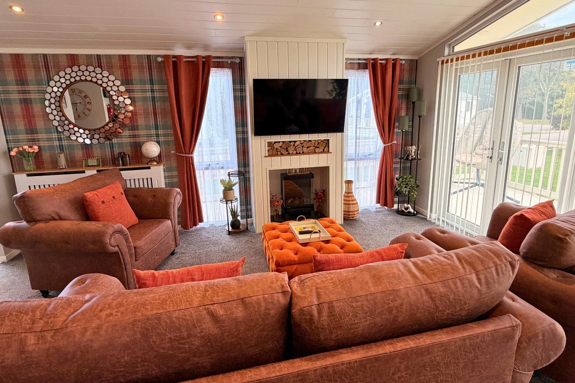 A living room with a fireplace, sofas, and a television.