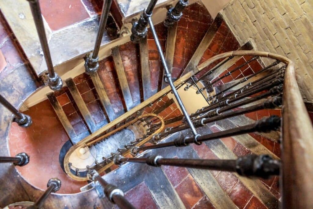 A spiral staircase with metal railings and a central support column.