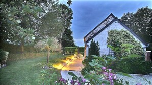 A house with a garden, a paved driveway, and a fence. - Le Cottage d'Etaville (Sottevast)
