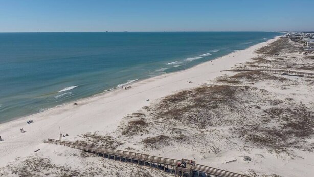 A beach with a wooden boardwalk, sandy beach, and ocean. - Beachfront Gulf Views Fort Morgan Pool Sleeps 7! (Gulf Shores)