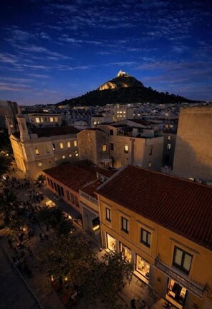 A historic town with a prominent hilltop fortress, traditional buildings, and a central square. - Elite Ermou Suites (Athens)