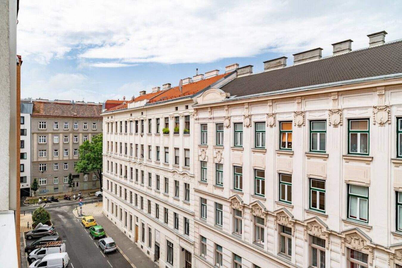 A multi-story building with a classic architectural style, featuring a symmetrical facade with evenly spaced windows and decorative moldings.