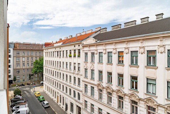 A multi-story building with a classic architectural style, featuring a symmetrical facade with evenly spaced windows and decorative moldings.