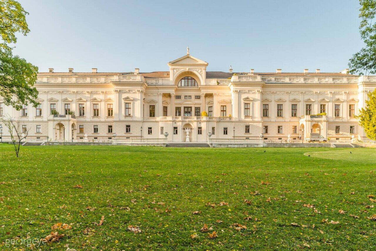 Un grand bâtiment de style classique, doté d’une façade symétrique, de nombreuses fenêtres et d’une entrée centrale.