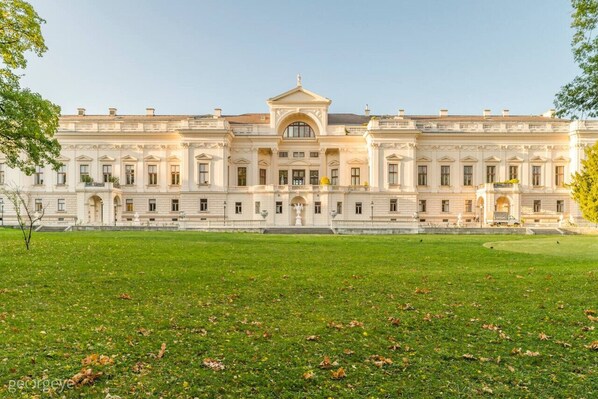 A large, classical building with a symmetrical facade, multiple windows, and a central entrance.