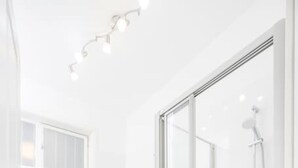 A modern bathroom with a glass-enclosed shower, a white sink, and a mirror above the sink. - Best of Hernals Top 30 (Vienna)