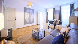 A modern living room with a sofa, coffee table, and artwork on the wall.