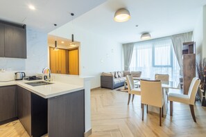 Comfort Apartment | Living area | 50-inch Smart TV with cable channels - SuperHost - Chic Modern 1BR Apt Retreat with City View (Dubai)