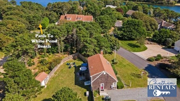An aerial view of a residential area with a path leading to a beach. - Wonderful dog friendly rental with access path to a private beach deeded at White's Pond! (Chatham)