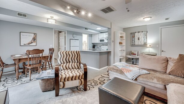A modern living room with a dining area, a kitchenette, and a cozy seating area. - Missouri Couple's Retreat: 'shouse' w/ Patio, Yard (Nixa)