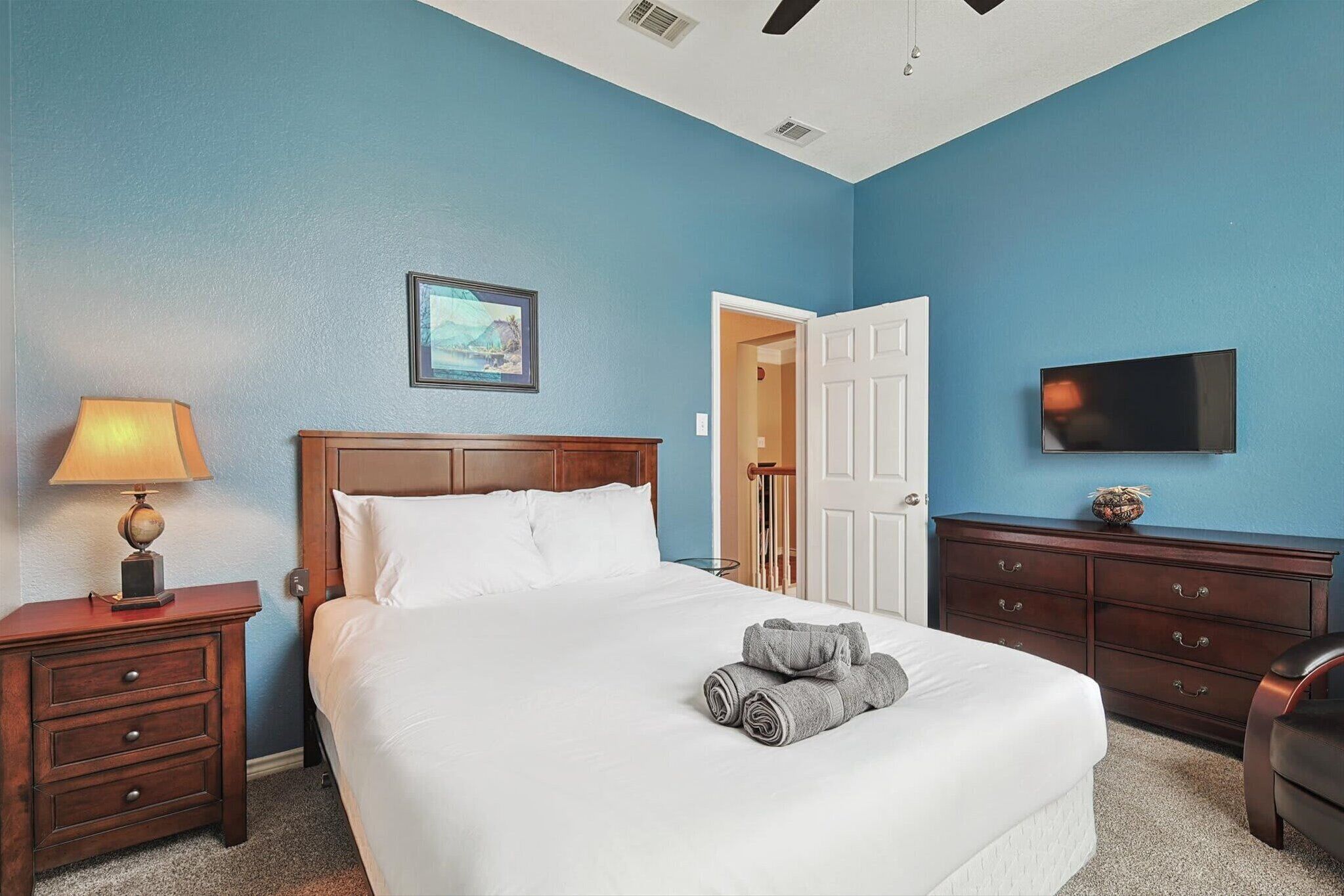 With a dedicated sitting area, wall-mounted TV, and unique architectural features, this bedroom is a place where you could hang out all day and night.