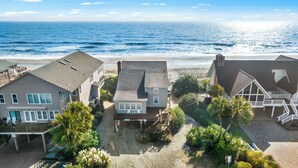 A coastal residential area with houses, a sandy beach, and the ocean. - Beach Nuts - Oceanfront, 4-bedrooms (Pawleys Island)