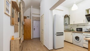 A modern kitchen with a refrigerator, microwave, washing machine, and a sink. - Venus Apartments - Oktogon I (Budapest)