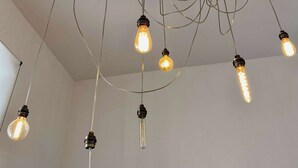 A ceiling with multiple exposed light bulbs.