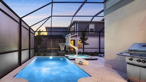 A swimming pool with a basketball hoop, a hot tub, and a grill area. - The Mystical | Ocean-lover's home w PVT pool, submarine theme BR, near waterpark (Orlando)