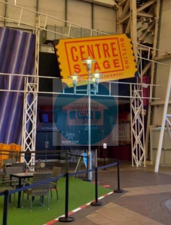 A Centre Stage sign with a blue circular logo below it. - Affordable Caravan Holidays, Butlins Minehead (Minehead)