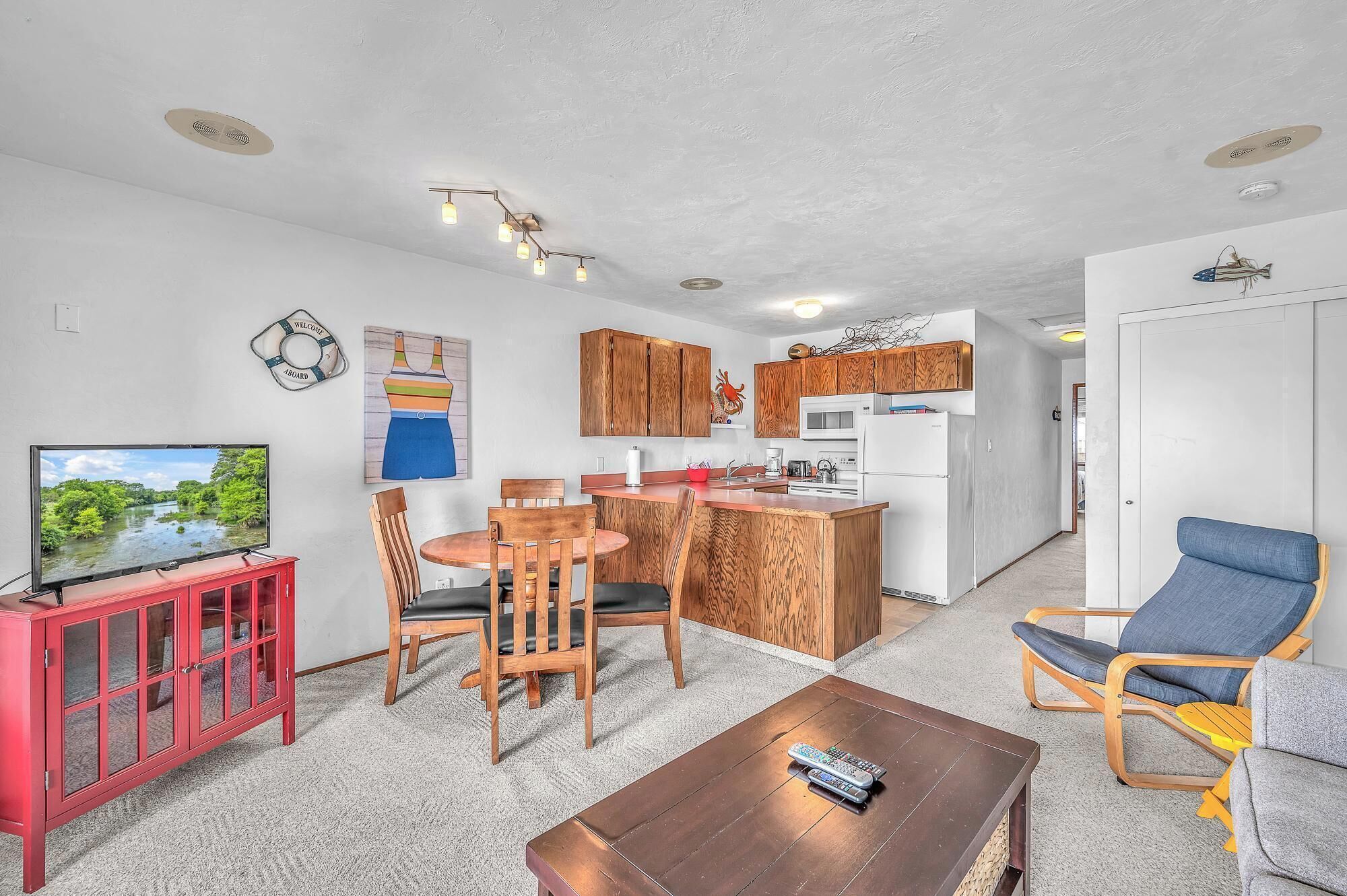 A compact living space with a kitchen, dining area, and seating.