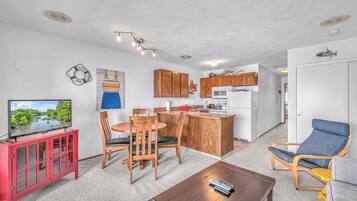 A compact living space with a kitchen, dining area, and seating.