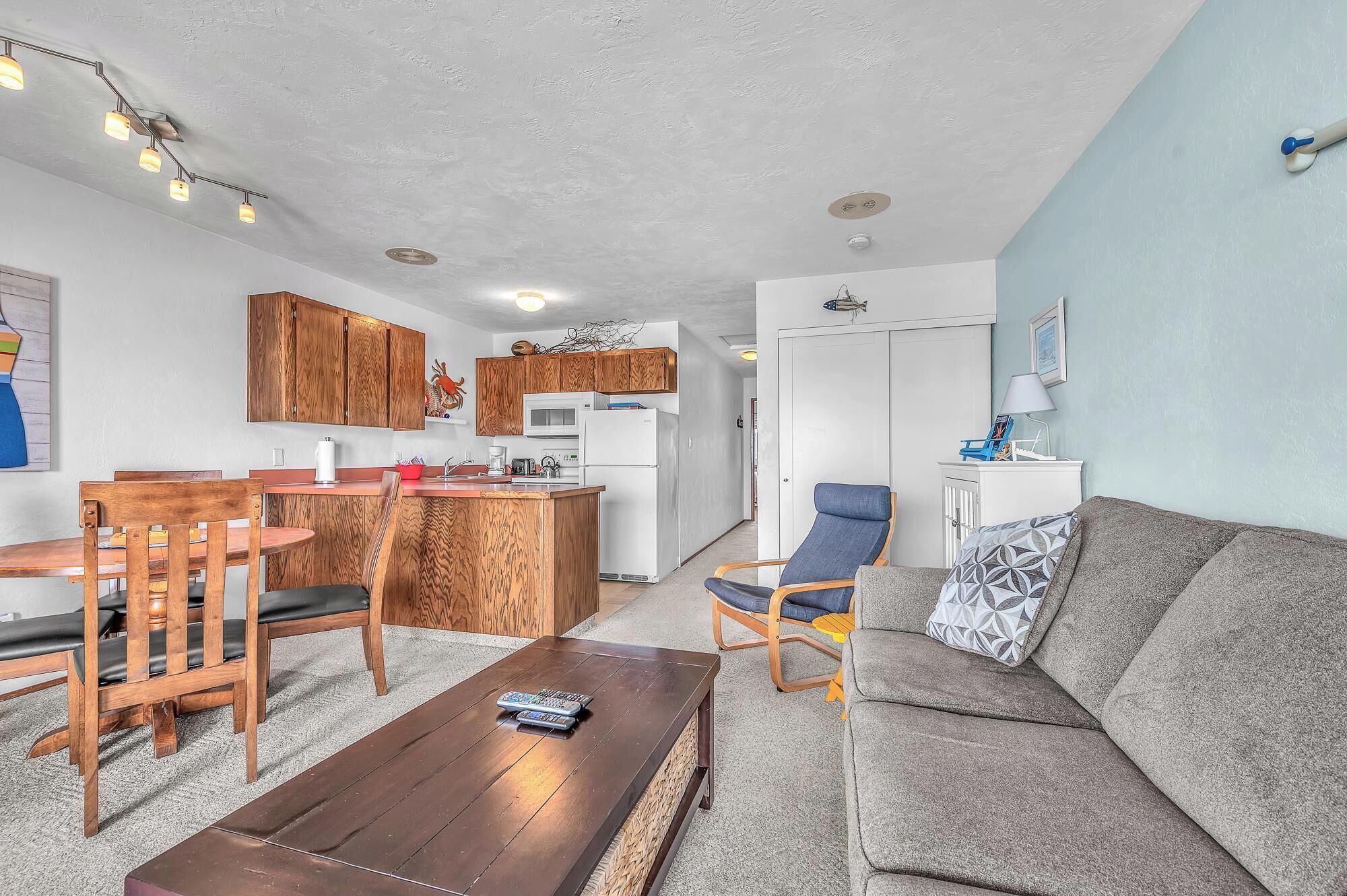 A compact living space with a kitchenette, a dining area, and a seating area.