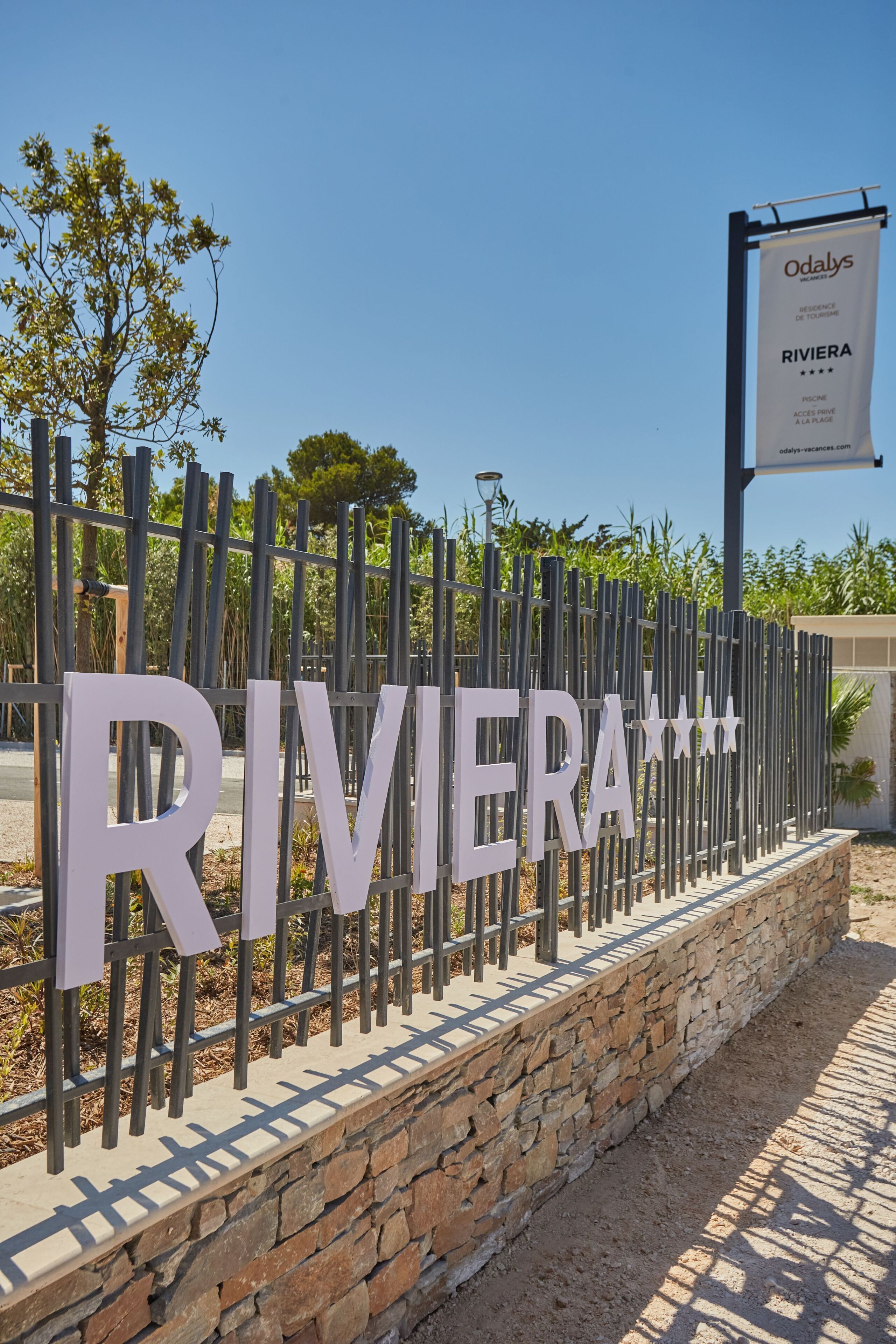 A sign with the name 'RIVIERA' and a banner for 'Odalys'.
