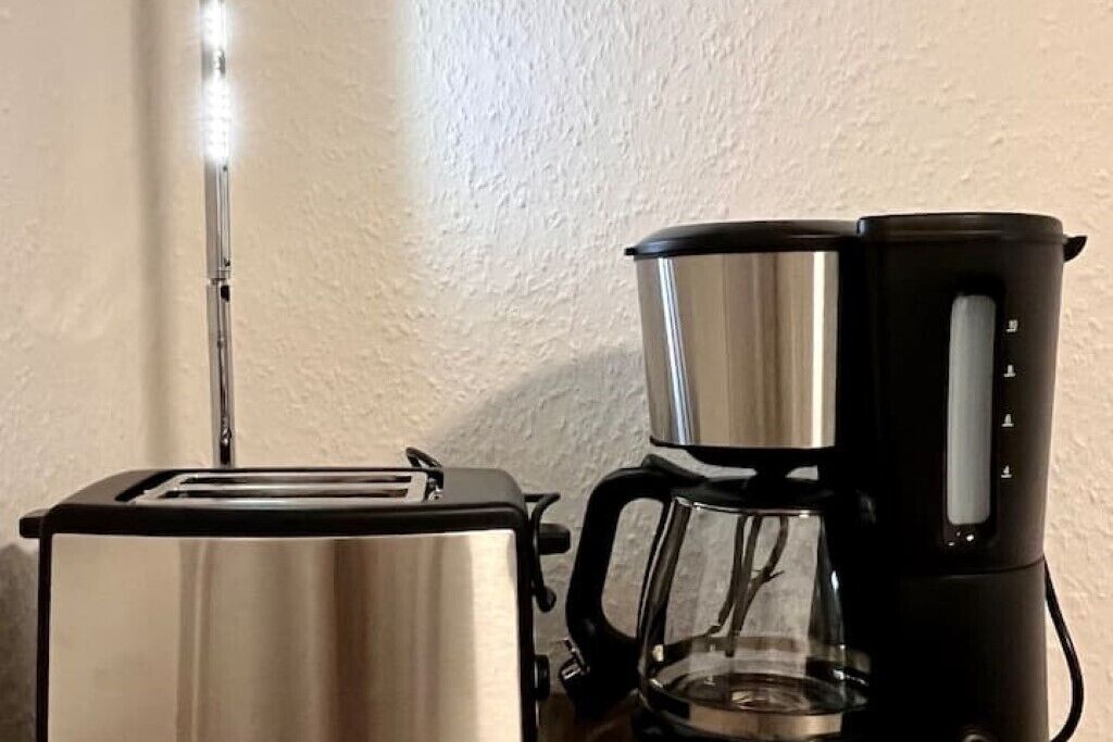 A toaster and a coffee maker on a countertop.