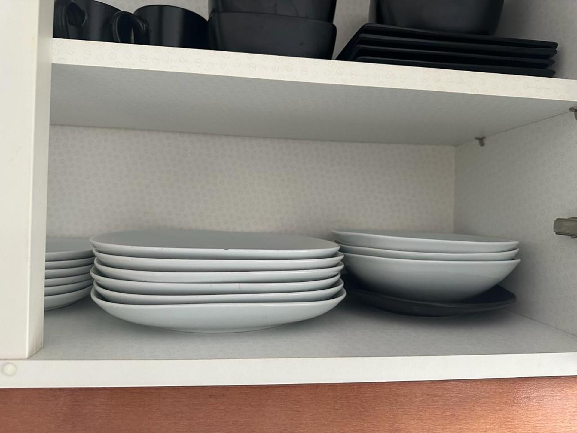 A kitchen with white cabinets and a countertop.