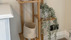 A wooden floor-to-ceiling shelving unit with various items. - Regency Style Spacious Seaview Apartment. Sleeps up to 6 (Brighton and Hove)