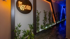 A hallway with a neon sign reading "the RSNita spa & wellness," bamboo plants, and a blue-lit pathway. - The Nirvanas Hotel (Istanbul)
