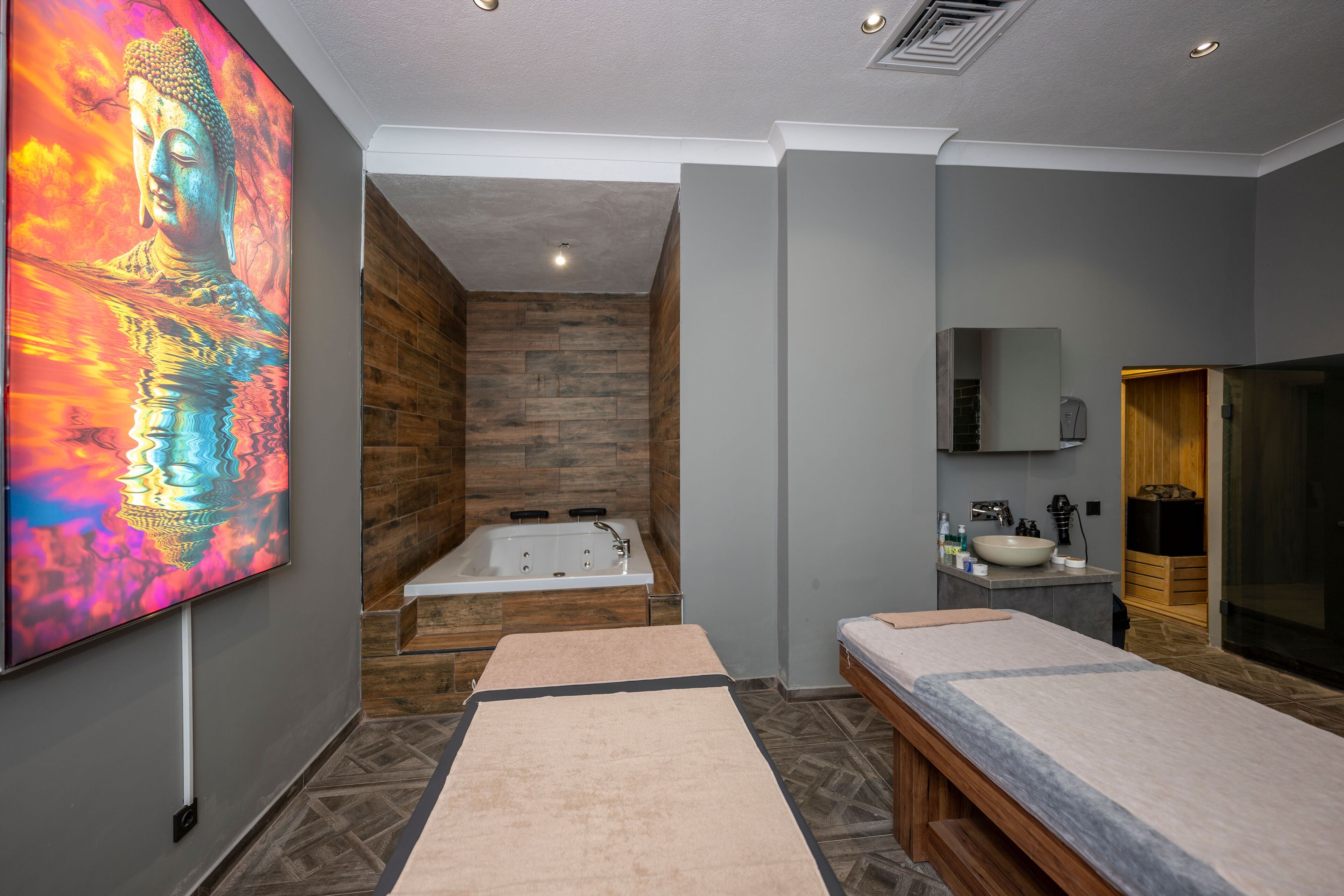 A modern bathroom with a wooden wall, a large mirror, a sink, and a bathtub.